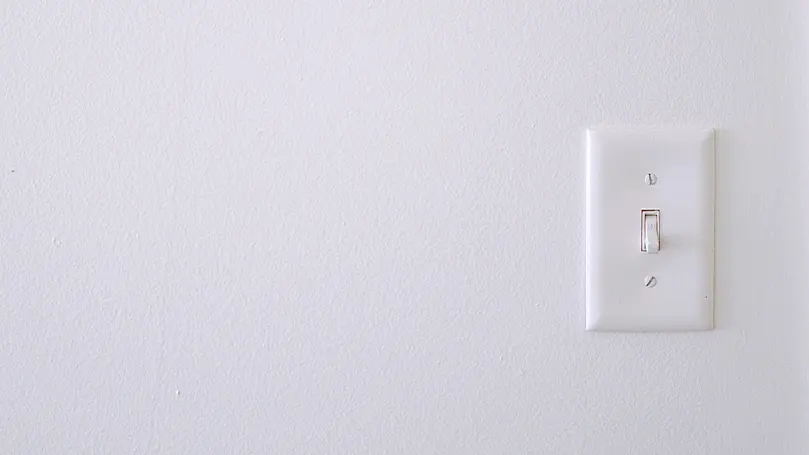 An image of a light switch on a white wall
