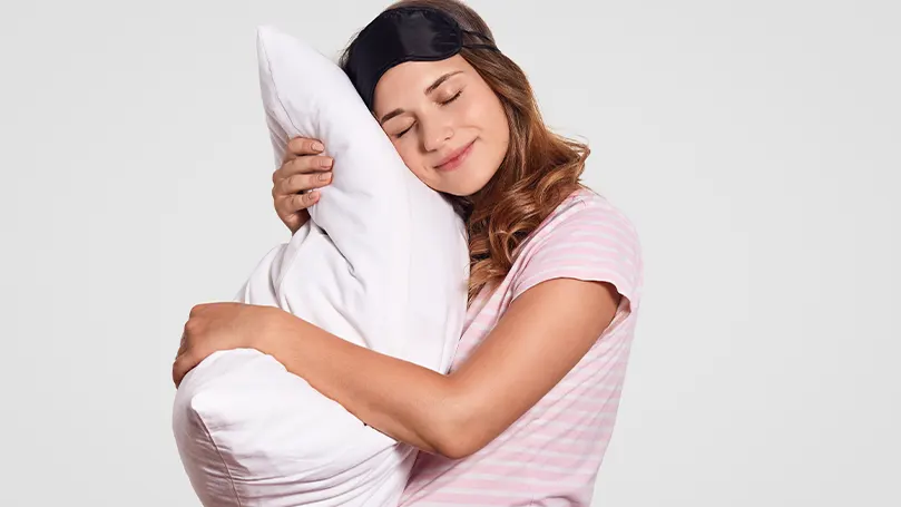 An image of a woman hugging her pillow