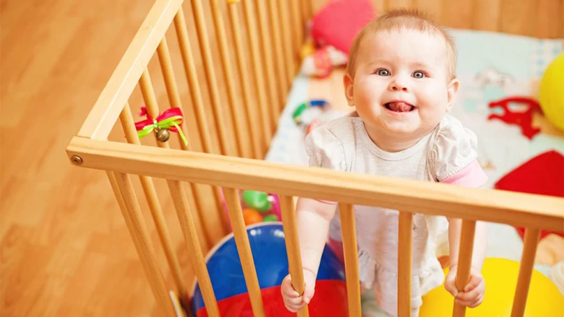 an image of a baby in a standard cot bed