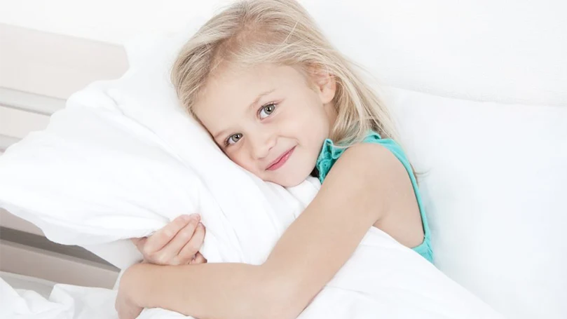 an image of a child hugging a hypoallergenic pillow