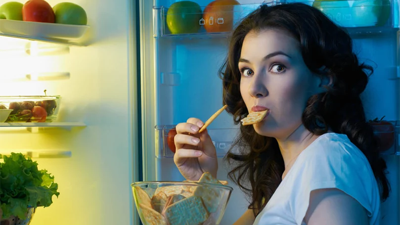 an image of a woman eating a heavy meal