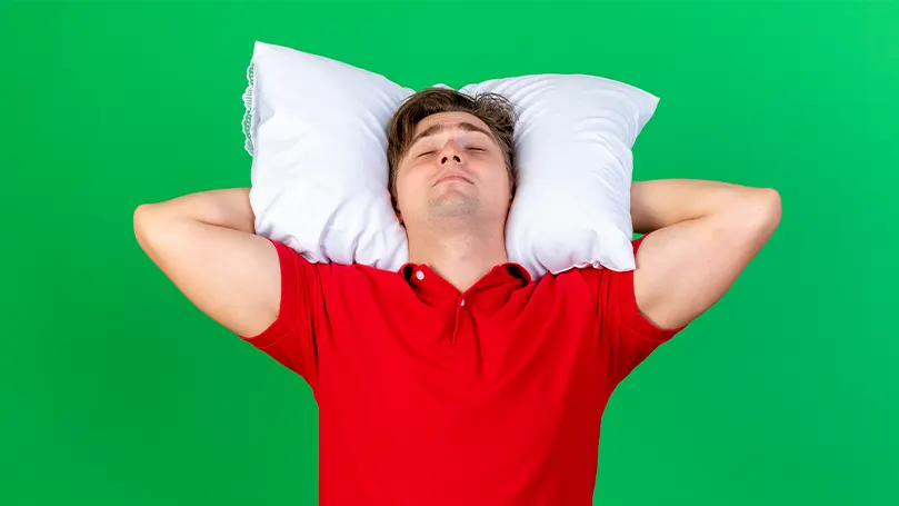 An image of a man sleeping on his back with his hands behind his head