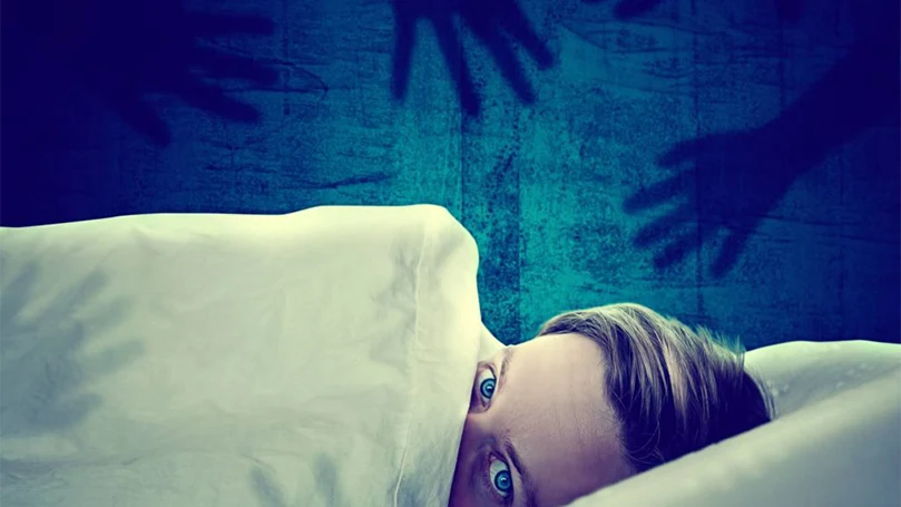 an image of a woman having a fear of sleep paralysis
