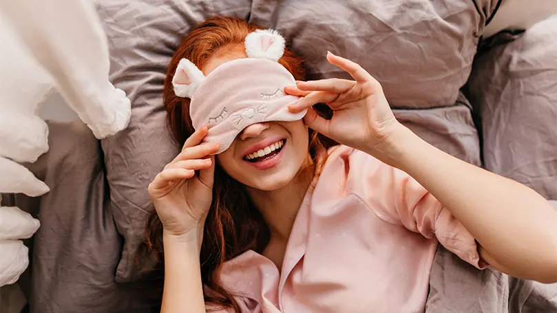 An image of a woman wearing a sleep mask.