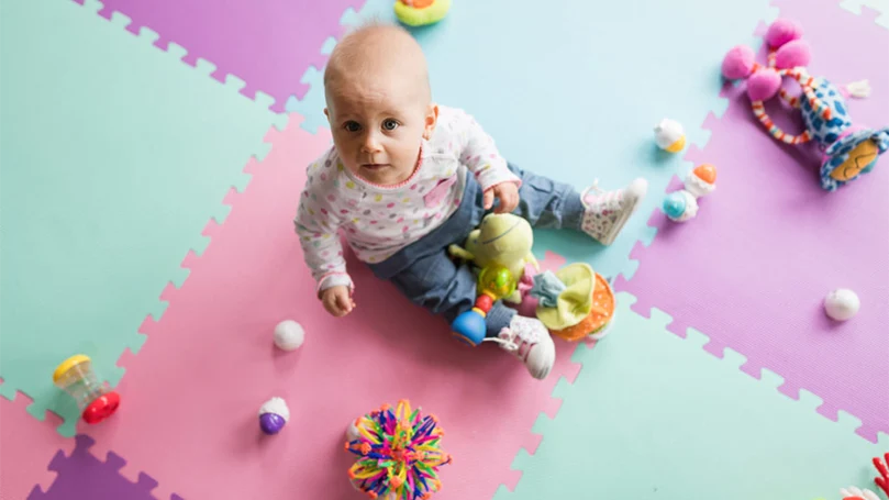 a baby playing on a floor