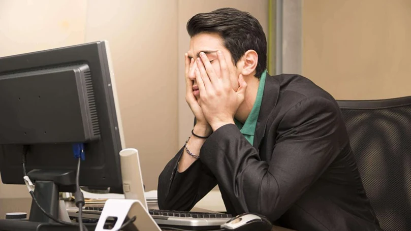 an image of a man working in front of the computer