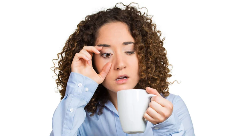 an image of a woman drinking coffee to stay awake