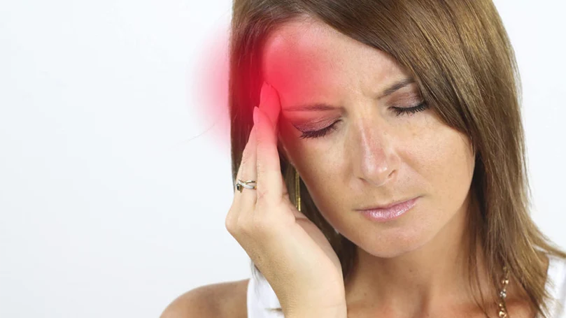 a woman having a migraine headache