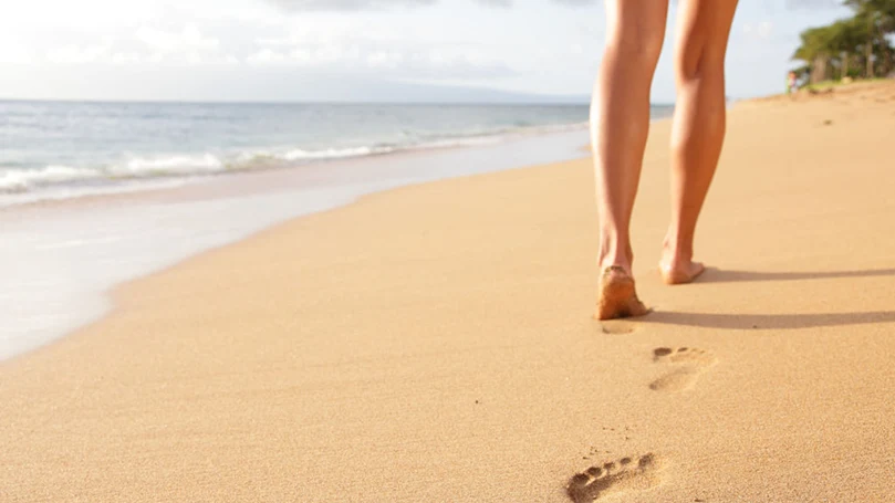 a woman walking on the beach