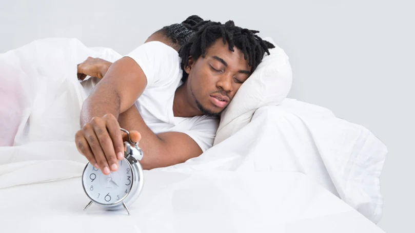 An image of a man snoozing the alarm