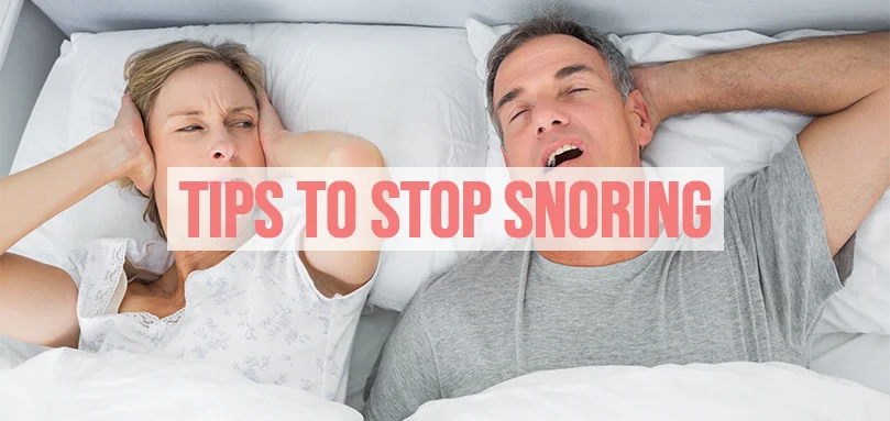 a woman trying to sleep next to a man who is snoring