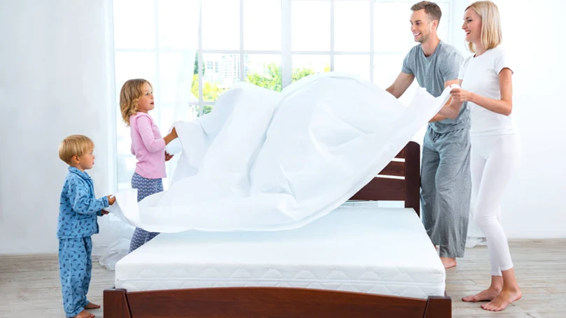 an image of a family that is cleaning a mattress
