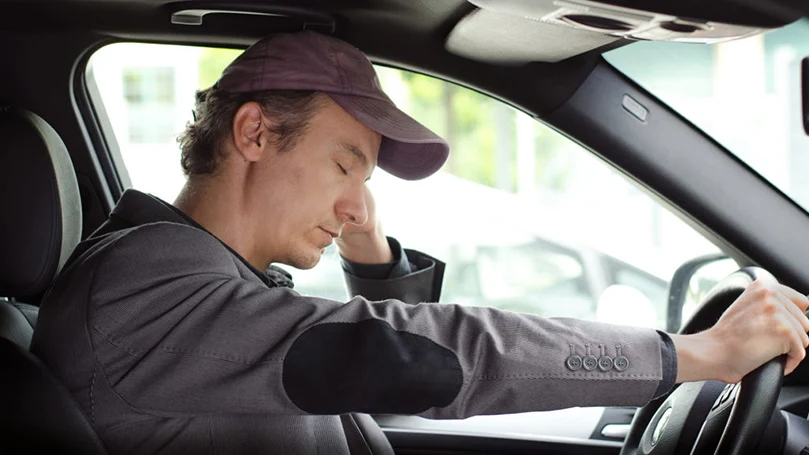 an image of a man sleeping in his car