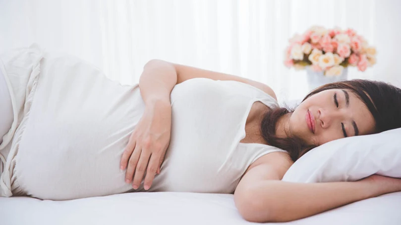 an image of a pregnant woman sleeping on side