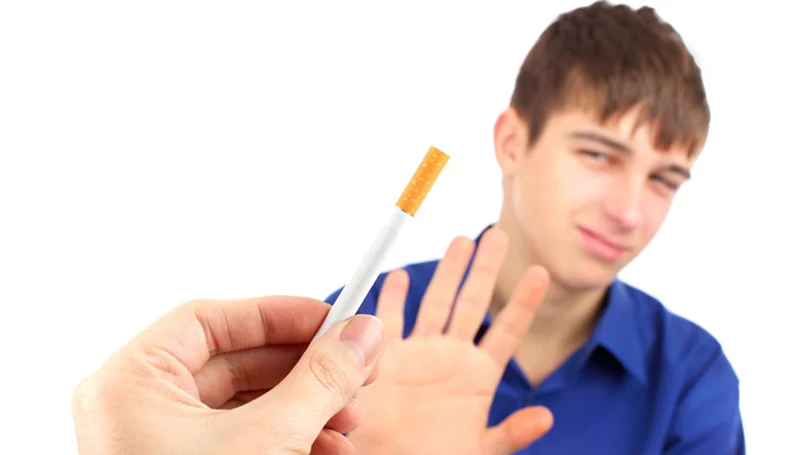 a young man refuses a cigarette