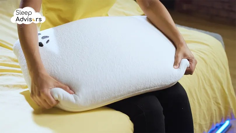 Panda pillow review - our presenter testing the pillow by squeezing it