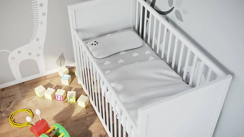 an image of panda memory foam bamboo luxury pillow in a baby cot bed
