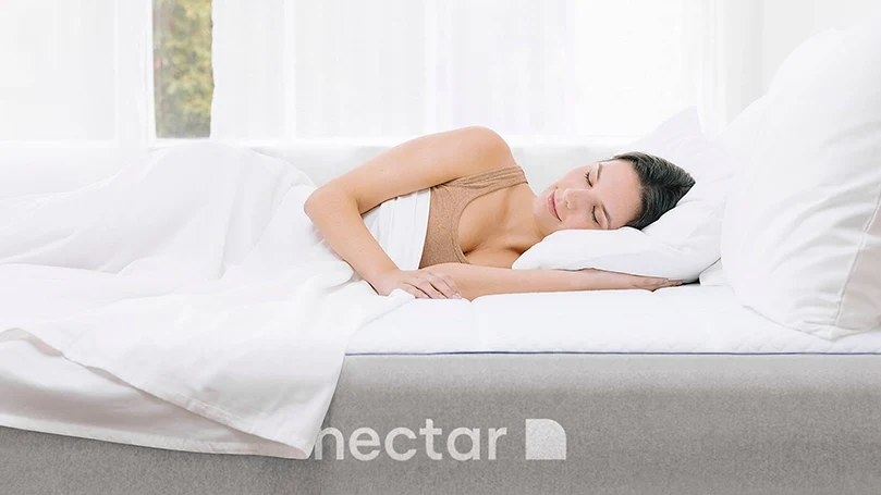 a woman laying on a nectar sleep mattress