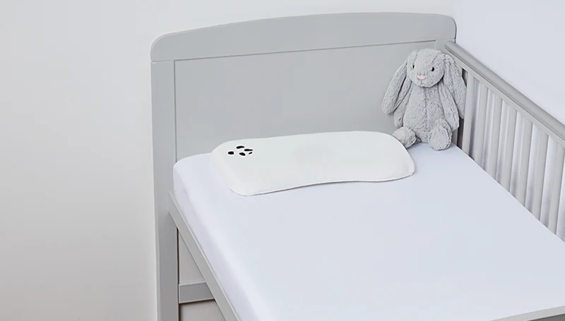 An image of Panda Kids Bamboo cot mattress in a cot bed.