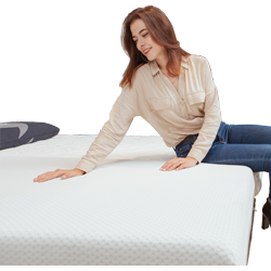 a girl sitting on a mattress