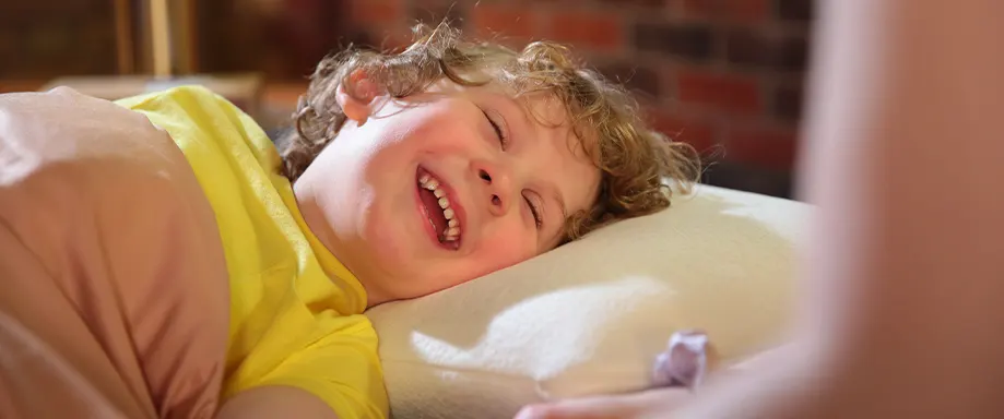 Toddler smiling while falling asleep