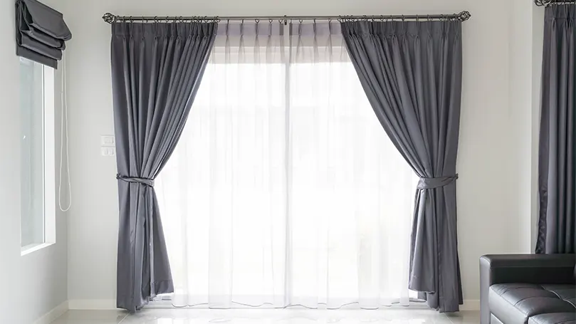 An image of open window curtains.
