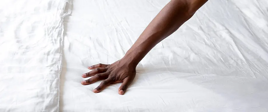 Hand on bed