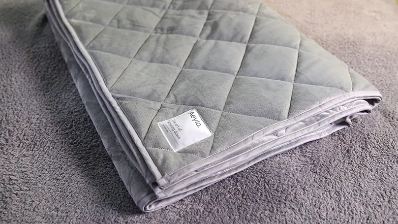 An image of a folded Mela weighted blanket
