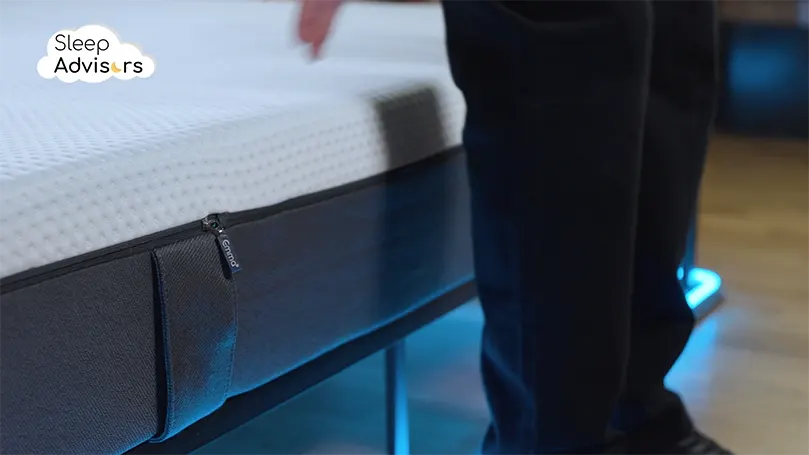 A close-up side shot of emma original mattress as our presenter stands next to it