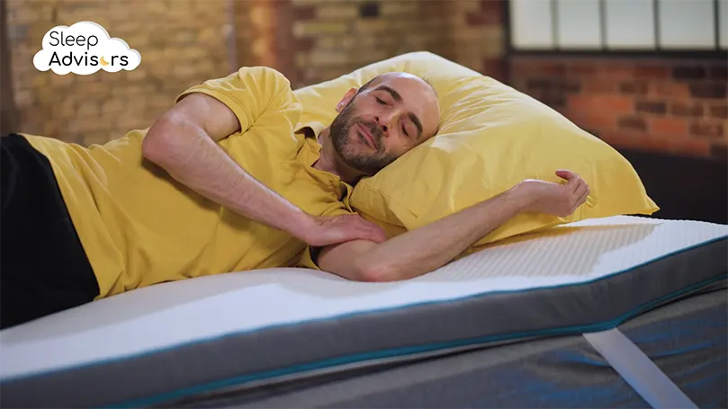 An image of a The Sleep Advisor reviewer sleeping on the Simba mattress topper