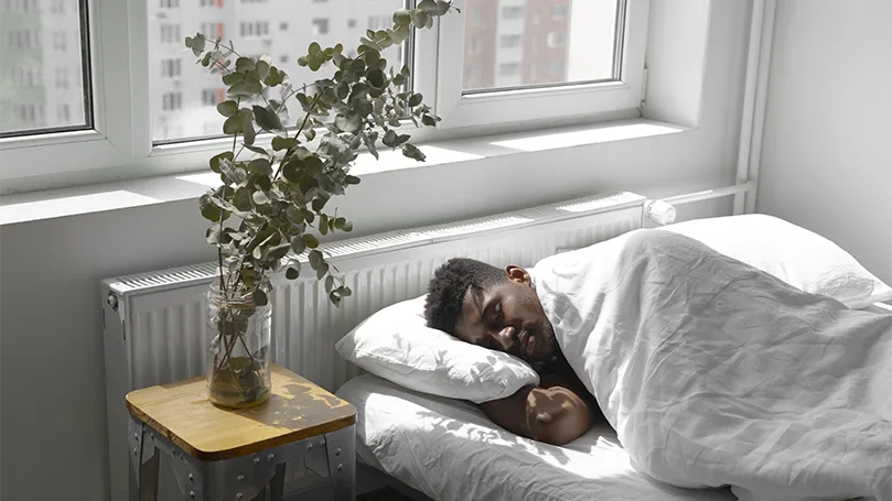 an image of a man sleeping in bed