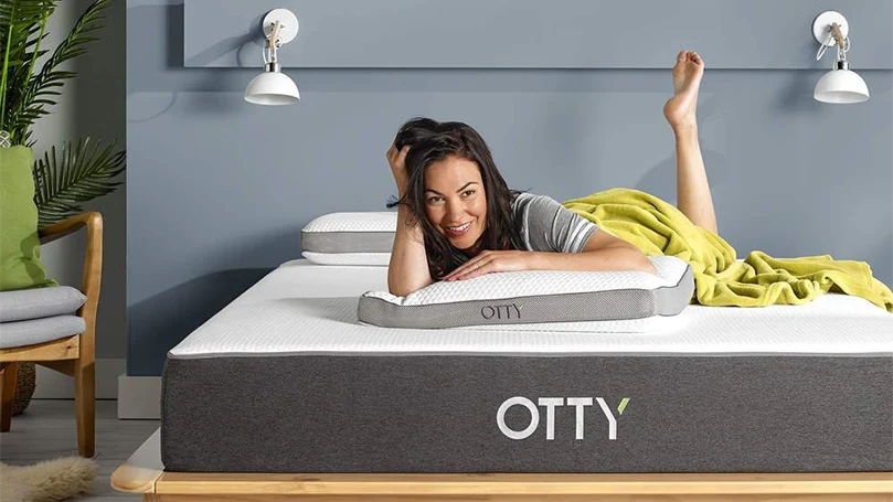 A woman laying on a Otty original hybrid mattress during the testing process