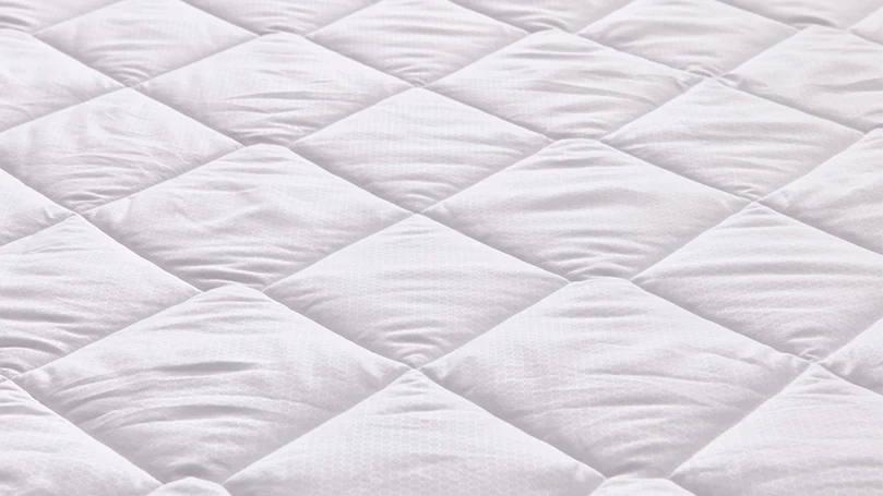 a close up image of eve breathe easy mattress protector