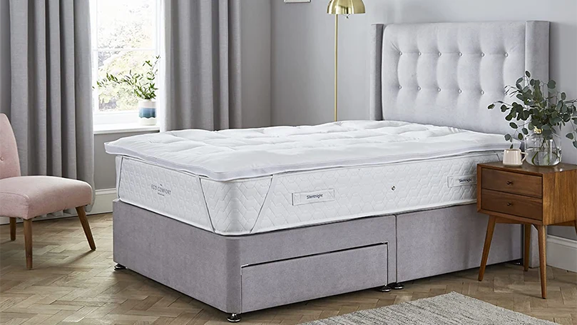 an image of Silentnight Squishy Mattress Topper on a mattress in a bedroom