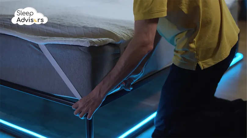 our reviewer purring RECCI mattress topper over a mattress