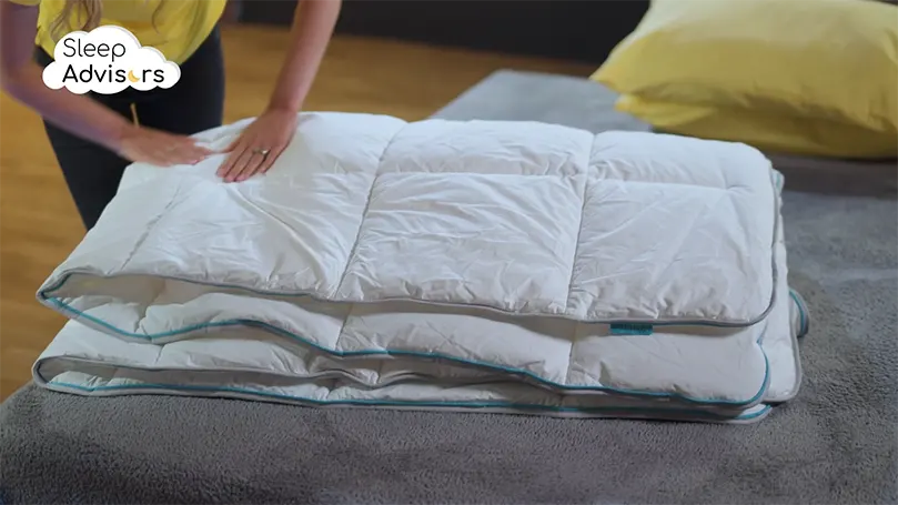Our reviewer testing a folded Simba hybrid duvet