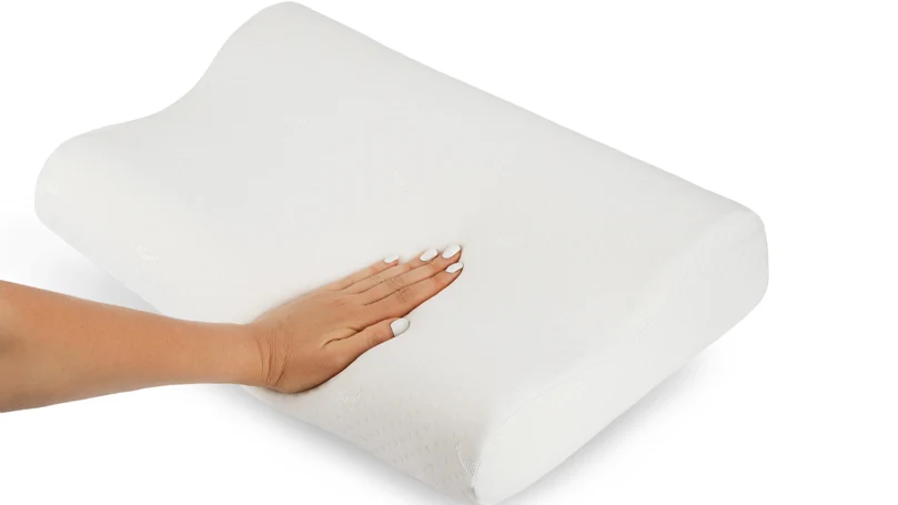 an image of a woman's hand pressing a memory foam pillow