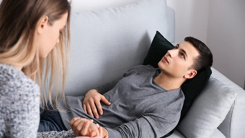 an image of a female sleep hypnotherapist working with a young male patient