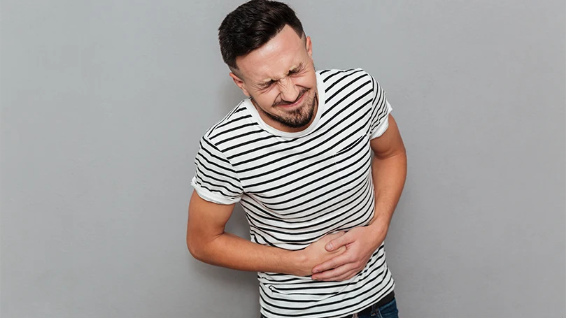 an image of a man having digestive problems