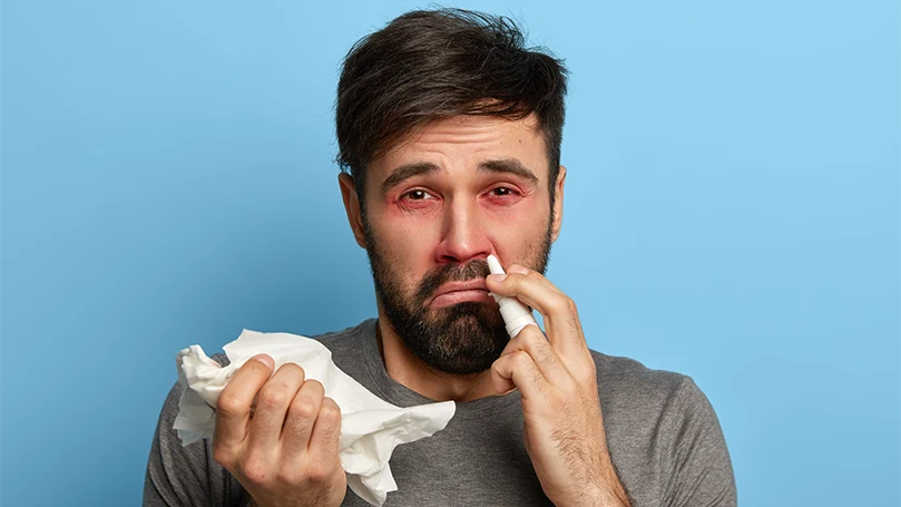 an image of a man having problem with allergies