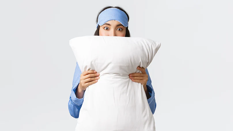 an image of a woman holding a pillow