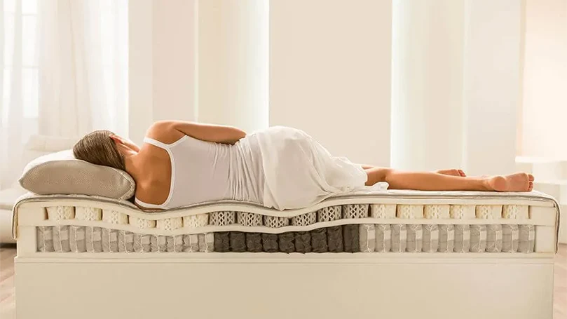 a-woman-laying-down-on-dormeo-octaspring-hybrid-plus-mattress