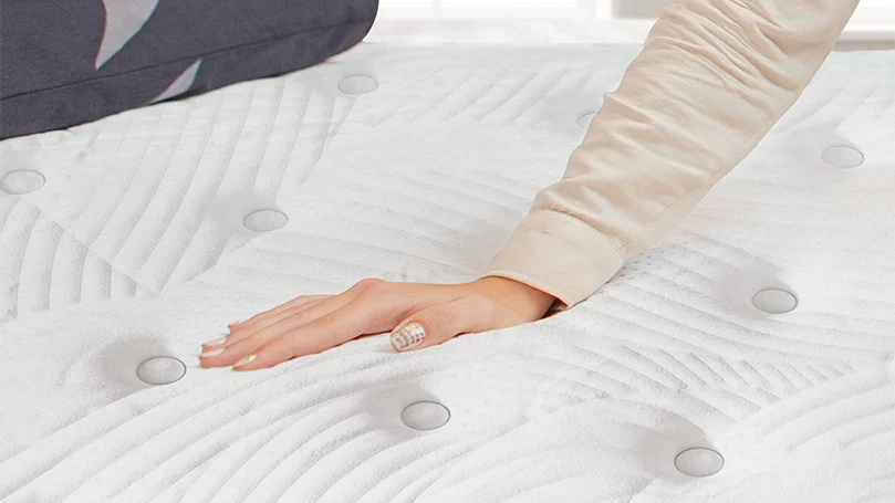 an image of a woman pressing the sweetnight mattress