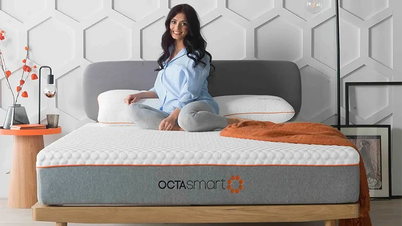 an image of a woman sitting on Dormeo Octasmart Hybrid mattress