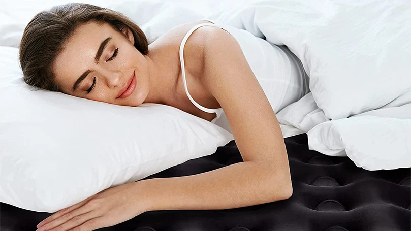 an image of a woman sleeping on an air mattress