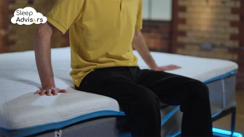 An image of a person testing the Inofia mattress topper