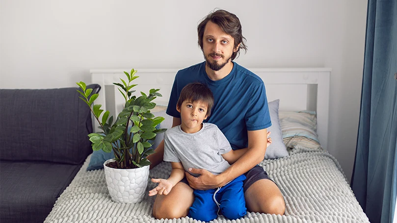 an image of a father and son having plants in the bedroom