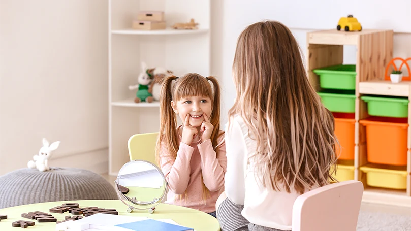 an image of a little girl talks to a therapist