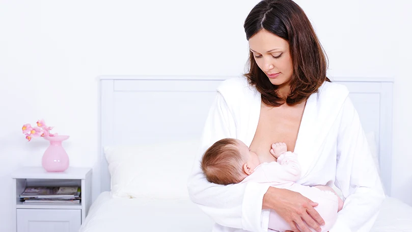 an image of a woman breastfeeding her baby