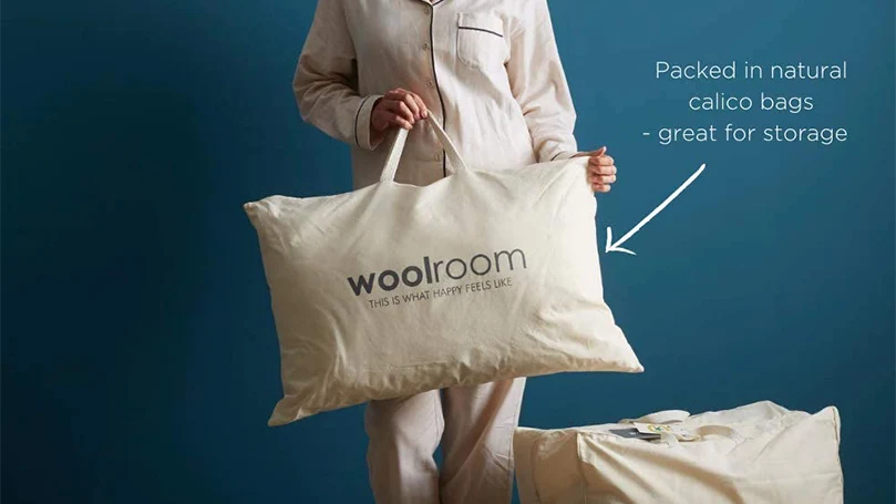 an image of a woman holding Woolroom Natural British Wool pillow